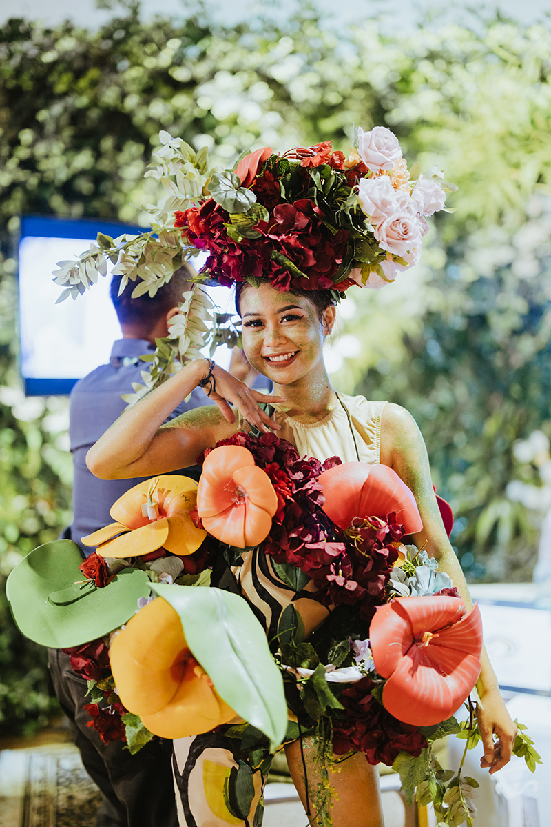 Women adorned in floral arrangement and exotic makeup