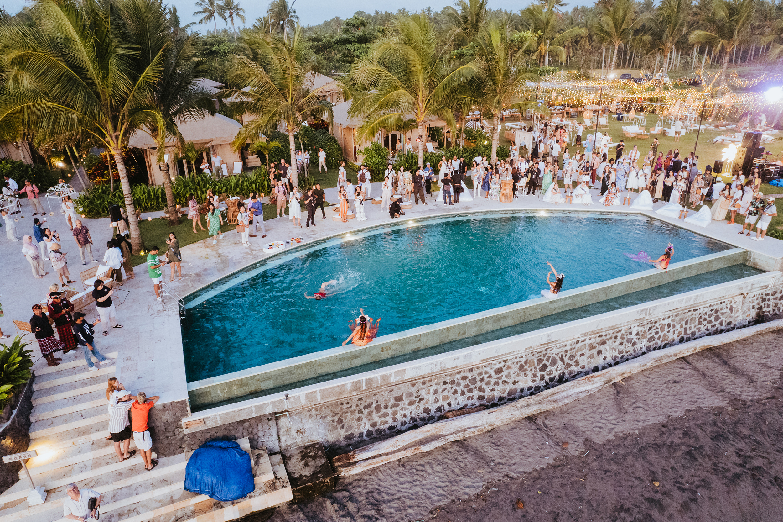 Overhead view of event around pool with palm trees